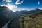 Aerial panorama of valley, morning fog over mountains, Twisting road, Tops and slopes of mountains