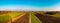 Aerial panorama view of countryside on sunny winter day in Styria , Austria. Route in beautiful nature landscape with sun, blue