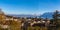 Aerial panorama view of Lausanne cityscape with snow covered French Alps and Lake Geneva Lake Leman in background on a sunny