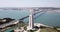 Aerial panorama view over the 25 de Abril Bridge and Statue of Jesus, Portugal