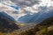 Aerial panorama view of Poschiavo town in valley with Swiss Alps and Lago di Poschiavo lake