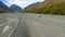 Aerial panorama view retro SUV automobile riding to glacier mountain river natural valley