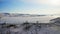 Aerial panorama. White buddhist stupa on top of snowy hill near frozen ice lake