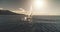 Aerial panorama of yacht race in open sea with sun reflections. Serene seascape with sailing boat
