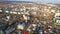 Aerial panoramic drone view of Chisinau in Moldova with roads, buildings, cars roofs of houses and autumn trees in