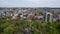 Aerial panoramic drone view of Chisinau in Moldova with roads, buildings, cars roofs of houses and spring trees in