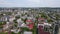 Aerial panoramic drone view of Chisinau in Moldova with roads, buildings, cars roofs of houses and spring trees in