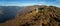 Aerial panoramic drone view of a lighthouse over Lake Como skyline with sunset light