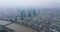 Aerial panoramic footage of city with high rise buildings in business hub. Hazy view of large town. Wide river calmly