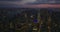 Aerial panoramic footage of downtown development at dusk. Lighted windows of high rise buildings and colourful twilight