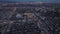 Aerial panoramic footage of metropolis after sunset. Evening shot of buildings and streets in boroughs of large city.