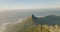 Aerial panoramic footage of mountains around town. Rugged sharp rock ridge on Table mountain and famous Lions Head