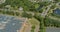 Aerial panoramic overview of solar system on a roof building warehouse near American small town