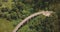 Aerial panoramic top view, drone turning left over Nine Arch Bridge Ella in Sri Lanka among exotic lush green trees.