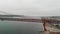 Aerial panoramic view of April 25 Bridge on a cloudy day, Lisbon