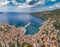 Aerial panoramic view of city Komiza - the one of numerous port towns in Croatia, is a lot of moored sailboats of a