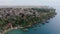 Aerial panoramic view of city at sea coast. Houses in old town district at high rocky slope above water. Antalya, Turkey