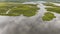 Aerial panoramic view on the coastal wetland with cloudedsky on the background