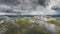Aerial panoramic view on the coastal wetland with rain cloudedsky on the