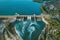 Aerial panoramic view of concrete Dam at reservoir with flowing water, hydroelectricity power station