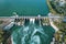Aerial panoramic view of concrete Dam at reservoir with flowing water, hydroelectricity power station, drone shot