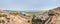 Aerial panoramic view from a drone of the beach on the Ein Bokek embankment on the coast of the Dead Sea, tourist hotels and car