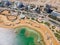 Aerial panoramic view from a drone of the beach on the Ein Bokek embankment on the coast of the Dead Sea, tourist hotels, the sea