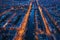 Aerial panoramic view of evening Amsterdam with water canals, illuminated roads and historic buildings, The Netherlands