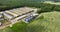 Aerial panoramic view and flight over silos and agro-industrial livestock complex on agro-processing and manufacturing plant with