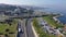 Aerial panoramic view of highway of modern coastal town.