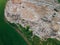 Aerial panoramic view of huge city garbage dump at sunset. Landfill disposal site. Birds fly over piles of trash. Wastes