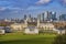Aerial panoramic view of London`s National Maritime Museum, the Royal Naval College Chapel and skyscrapers of Canary Wharf from