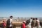 Aerial panoramic view of Lyon with children tourists pointing at the skyline and the Incity tower and Le Crayon during afternoon