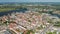 Aerial panoramic view of old town. Historic landmarks from above. City in flat coastal landscape