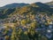 Aerial panoramic view over the picturesque village Papigo in Epirus, Greece at sunset. Scenic aerial view of traditional Greek