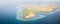 Aerial Panoramic view of Pinisi Ship, Reef, and Island