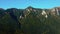 Aerial panoramic view of rocky mountains range. Video from drone flying over forested and cliffs slopes of Carpathian Mountains