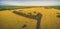 Aerial panoramic view of rural road passing through agricultural land in Australian countryside.