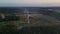 Aerial panoramic view of two windmill with rotating blades, working wind turbine among the woodlands