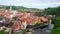 Aerial panoramic view of the typical colorful houses of Cesky Krumlov with Vltava river at the foreground and St. Vitus Church at