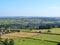 An aerial panoramic view of west yorkshire countryside near luddenden with cows grazing in meadows and farmhouses with the village