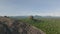 Aerial panoramic view of wooded landscape on sunny day. revealing rocky outcrop towering above forest. Sigiriya, Sri