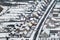 aerial panoramic winter view of village with houses, barns and gravel road with snow