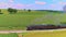 Aerial Parallel View of a Steam Passenger Train Blowing Black Smoke Traveling Thru Fertile Corn Fields