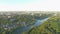 Aerial paraplane hang glider in the air above river city canyon