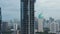 Aerial pedestal shot of modern glass skyscraper under construction in Jakarta, Indonesia