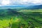 Aerial perspective view on sudety mountains during cloudy day with villages in the valley surrounded by meadows, forest and