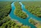 Aerial perspective of a winding river through a dense mangrove forest under clear blue skies. AI generated.