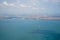 Aerial photo from airplane showing Istanbul cityscape with ocean water, coast, ships, buildings and sky background