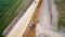 Aerial photo of a backhoe loader and a steamroller on a road work